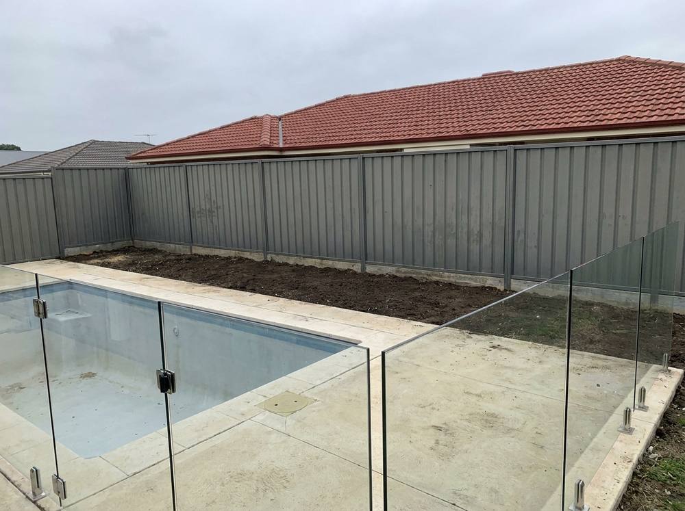 A pool fence line, before planting